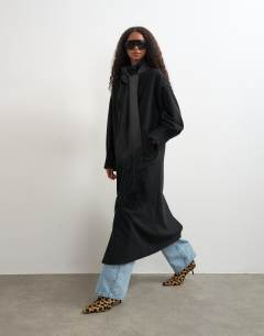 Model wearing Fringe detail belted longline coat with wool in black