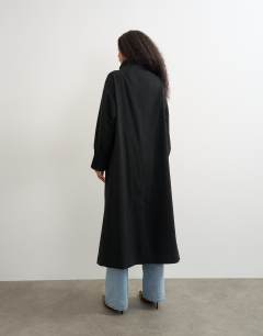 Model wearing Fringe detail belted longline coat with wool in black