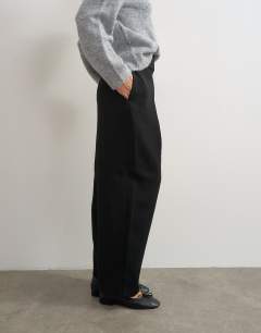 Model wearing Front pleat wide leg trouser in black