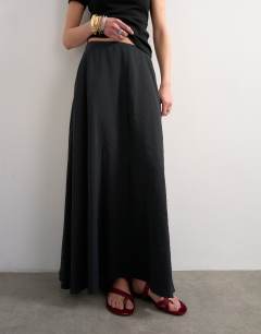 Model wearing Full circle cupro maxi skirt in black