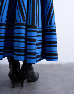 Model wearing Full circle cut about maxi skirt in blue and black stripe