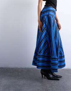 Model wearing Full circle cut about maxi skirt in blue and black stripe