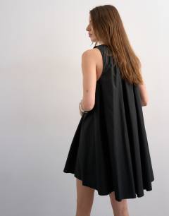 Model wearing Full hem pleated mini sundress in black