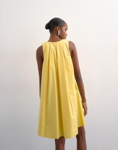 Model wearing Full hem pleated mini sundress in lemon