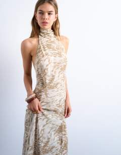 Model wearing Full neck halter midi dress in beige abstract zebra