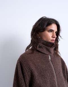 Model wearing Funnel boucle tab detail bomber in chocolate