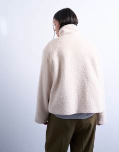 Model wearing Funnel boucle tab detail bomber in cream