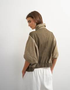 Model wearing Funnel mock sleeve sports top in olive