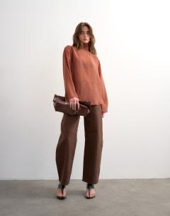 Model wearing Funnel neck backwards long sleeve shirt in rust