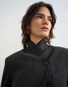 Model wearing Funnel neck blazer in black