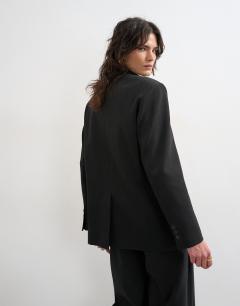 Model wearing Funnel neck blazer in black