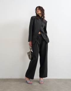 Model wearing Funnel neck blazer in black