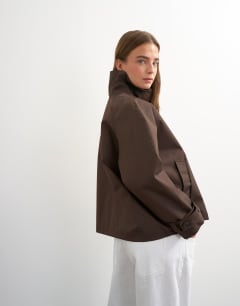 Model wearing Funnel neck cropped trench coat in chocolate