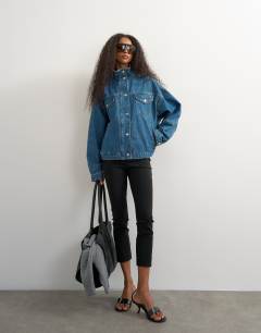 Model wearing Funnel neck denim jacket elasticated hem in green cast