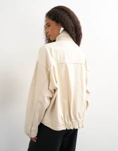 Model wearing Funnel neck denim jacket in natural