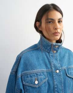 Model wearing Funnel neck elastic hem detail jacket mid blue