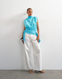 Model wearing Funnel neck gathered waist tie detail top in blue