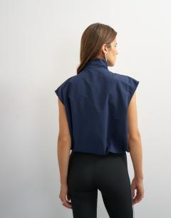 Model wearing Funnel neck grown on sleeve tech top in navy