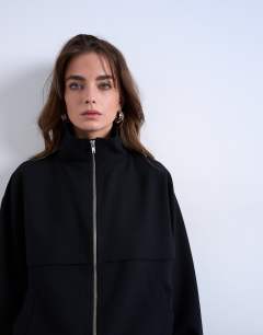 Model wearing Funnel Neck Jacket in black