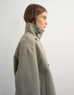 Model wearing Funnel neck jacket in grey