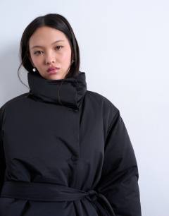 Model wearing Funnel neck longline belted puffer jacket in black