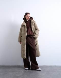 Model wearing Funnel neck longline belted puffer jacket in stone