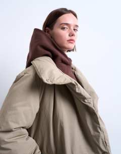 Model wearing Funnel neck longline belted puffer jacket in stone