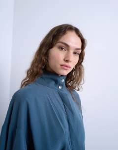 Model wearing Funnel neck mini dress in dusty blue