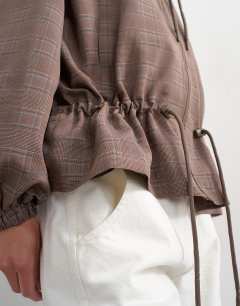 Model wearing Funnel neck nylon check anorak in multi