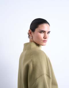 Model wearing Funnel neck oversized sweat in khaki