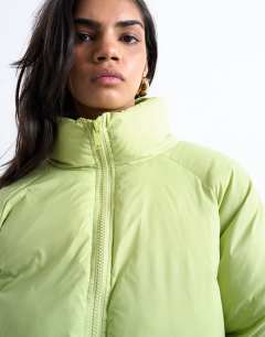 Model wearing Funnel neck puffer bomber jacket in leaf green