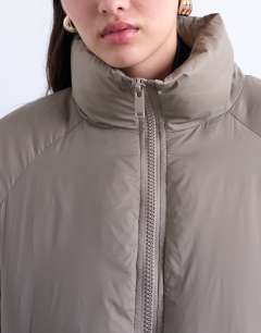 Model wearing Funnel neck puffer bomber jacket in mushroom