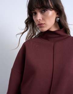 Model wearing Funnel neck seam detail sweatshirt in chocolate