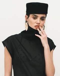 Model wearing Funnel neck sheer organza top in black