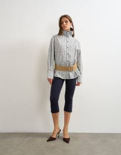 Model wearing Funnel neck shirt in check print