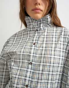 Model wearing Funnel neck shirt in check print