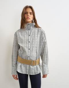 Model wearing Funnel neck shirt in check print