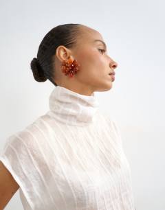 Model wearing Funnel neck sleeveless top in ivory stripe