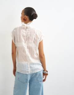 Model wearing Funnel neck sleeveless top in ivory stripe