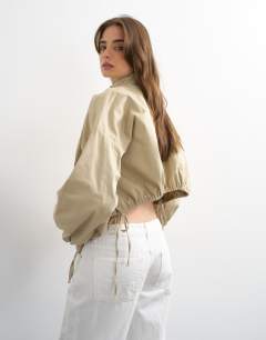 Model wearing Funnel neck tie detail shirt in stone