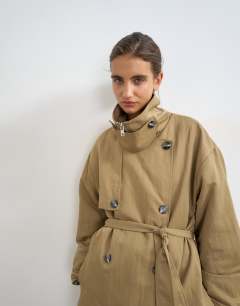 Model wearing Funnel neck trench in camel