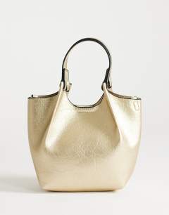 Model wearing Gabbie grab bag small with detachable cross body strap in gold