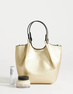 Model wearing Gabbie grab bag small with detachable cross body strap in gold