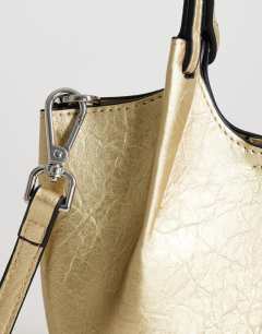 Model wearing Gabbie grab bag small with detachable cross body strap in gold