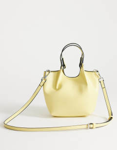 Model wearing Gabbie grab bag small with detachable cross body strap in lemon 