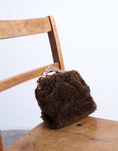 Model wearing Gabriette borg metal trim handle grab bag in brown