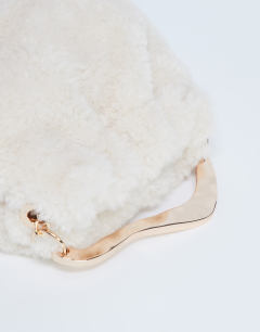 Model wearing Gabriette borg metal trim handle grab bag in cream