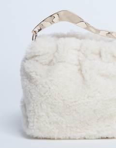 Model wearing Gabriette borg metal trim handle grab bag in cream