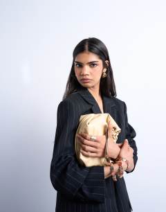 Model wearing Gabriette metal trim handle grab bag in buttermilk