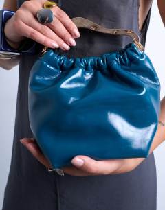 Model wearing Gabriette metal trim handle grab bag in teal